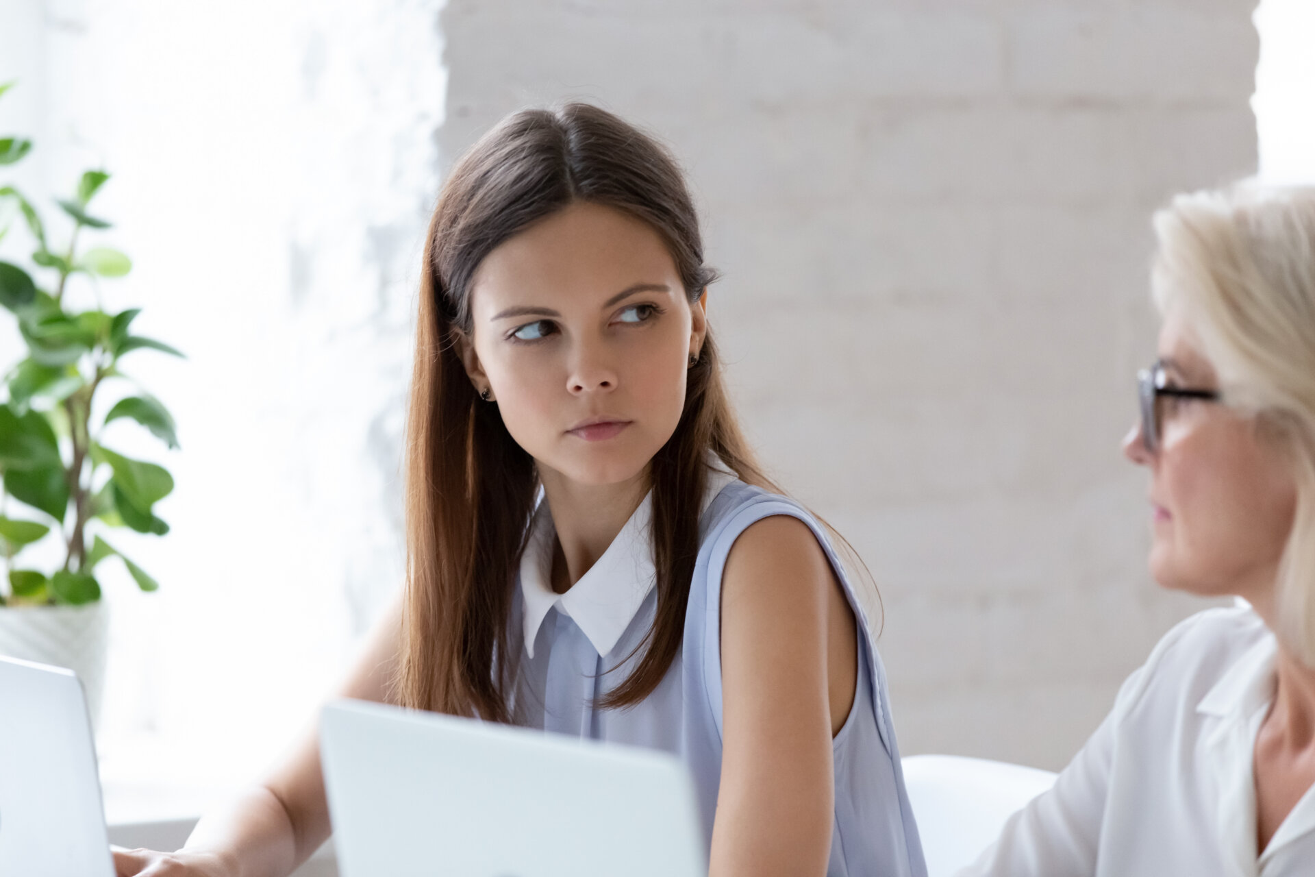Serious,Millennial,Woman,Worker,Sit,At,Office,Desk,Looking,Angry